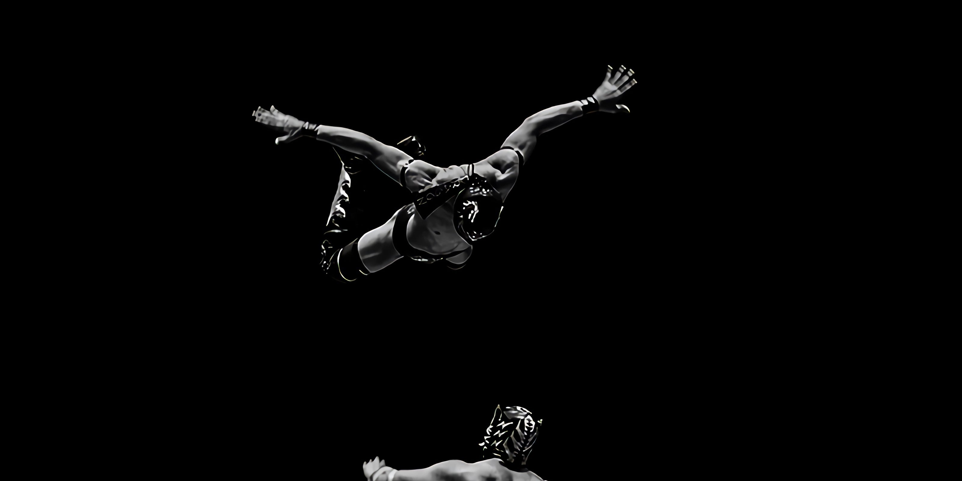 Two Luchadores with One Flying off Ropes at the Other