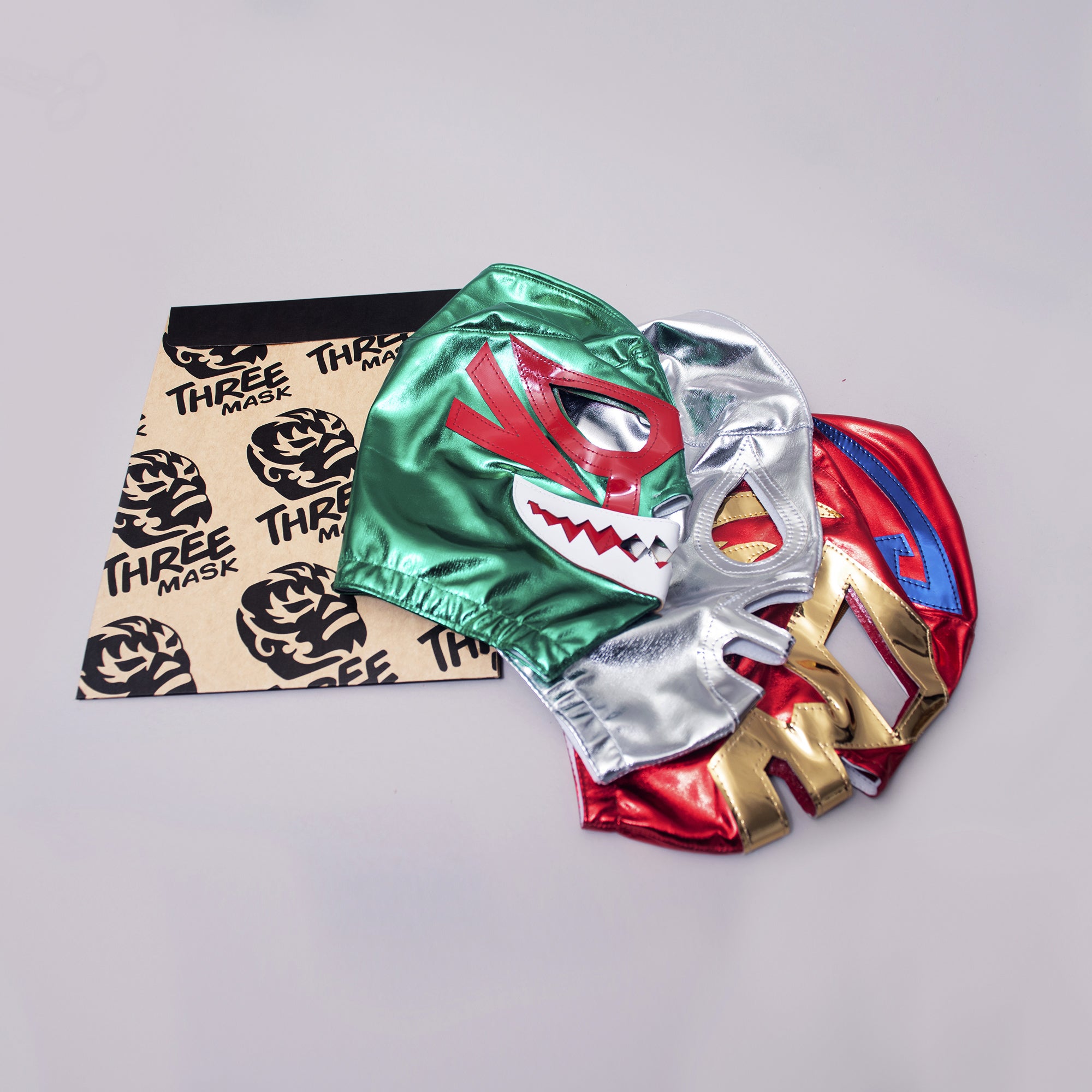 Green, silver & red mexican wrestling masks with packaging